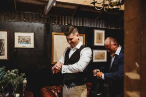 Gledswood Wedding - groom's father helps him prepare for the ceremony