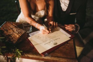 Gledswood Wedding - A bride and groom sign the marriage certificate after the ceremony