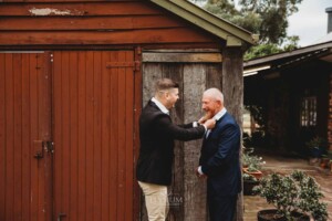 Gledswood Wedding - A groom adjusting his dads tie before the wedding ceremony at Gledswood