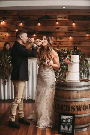 Gledswood Wedding - Bride and groom share a toast after cutting their wedding cake