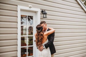 Gledswood Wedding - A groom kisses his bride during their first look before the wedding ceremony