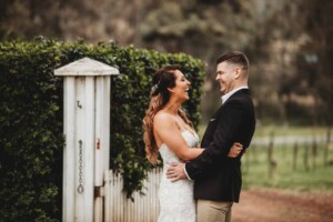 Gledswood Wedding - A bride and groom laugh together on the dirt driveway at Gledswood before the wedding