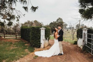 Gledswood Wedding - A bride and groom laugh together on the dirt driveway at Gledswood before the wedding