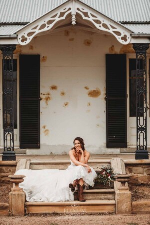 Gledswood Wedding - A bride sits on the steps of the homestead