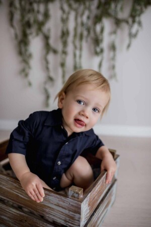 Cheeky baby boy pokes his tongue out for a photograph