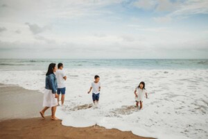 A family splash in the water at the beach