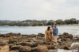 Family Photographer - A family walk along the rocks of Balmoral beach at sunset