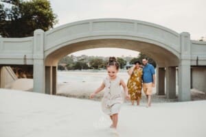 Family Photographer - a little girl gets ready to run and hug her parents