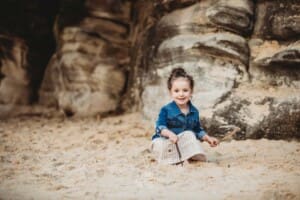 Family Photographer - A little girl plays in the sand at Balmoral Beach