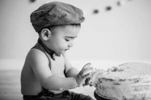 A baby boy experiencing the feeling of cake icing for the first time