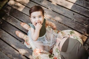 Family Photographer - A little girl sitting on her mothers lap