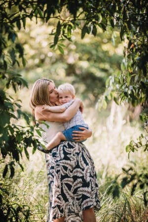 Family Photographer - A mother cuddles her baby boy