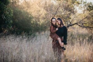 Family Photographer - a mother holds her daughter in her arms