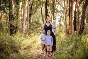 Family portrait of a mother and her 3 boys, bushland at sunset