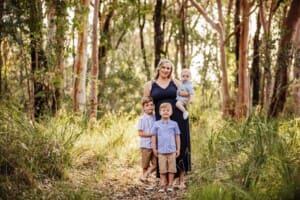 Family portrait of a mother and her 3 boys, bushland at sunset