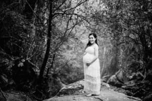 Maternity Session - Pregnant mamma stands on a rock in the bush
