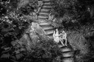 Family Session - parents sit with their baby boy on sandstone steps at Lennox Bridge