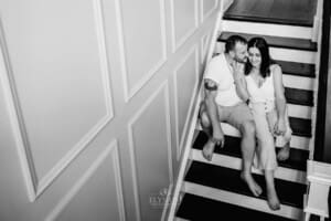 Family session - a couple sitting on stairs cuddling
