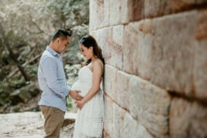 Maternity session - a husband gently holds his wife's pregnant belly