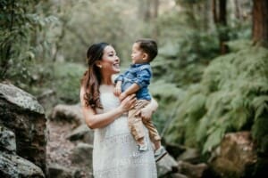 Maternity session - a pregnant mother holds her little boy and cuddles him