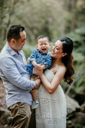 Family Session - Parents cuddle their baby boy between them