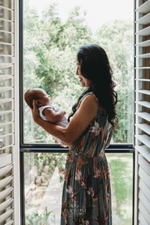 Newborn session - a grandmother holds a newborn baby in her arms