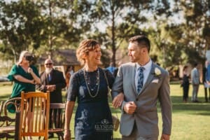 Gledswood Wedding - groom walks with his mother down the aisle