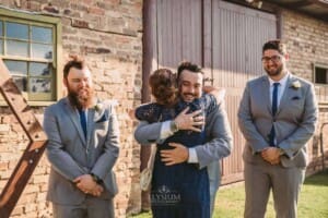 Gledswood Wedding - groomsman hugs the groom's mother