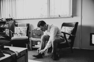 Gledswood Wedding - groom putting his shoes on before the ceremony