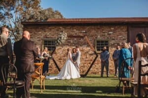 Gledswood Wedding - bride and groom stand at the front of the ceremony