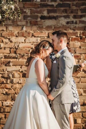 Gledswood Wedding - groom kisses his bride on the forehead