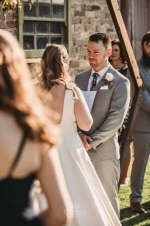 Gledswood Wedding - groom listens to the bride reading her vows