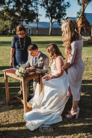 Gledswood Wedding - bride and groom sign their marriage certificate