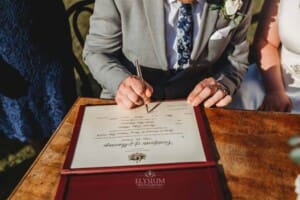 Gledswood Wedding - bride and groom sign their marriage certificate