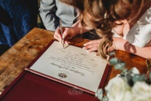 Gledswood Wedding - bride and groom sign their marriage certificate