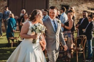 Gledswood Wedding - bride and groom walk down the aisle after the ceremony
