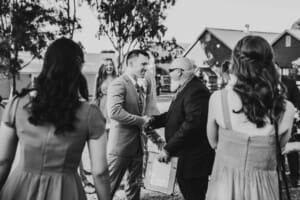 Gledswood Wedding - groom greets guests after the ceremony