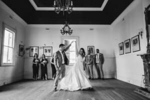 Gledswood Wedding - groom twirls the bride as the practice dancing