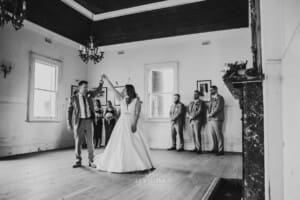 Gledswood Wedding - groom twirls the bride as the practice dancing