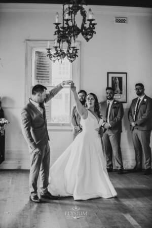 Gledswood Wedding - groom twirls the bride as the practice dancing
