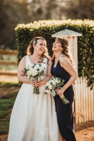 Gledswood Wedding - bridal laughs with her bridesmaid