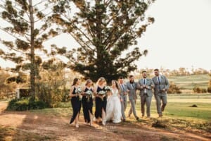 Gledswood Wedding - bridal party walk across the venue grounds at sunset
