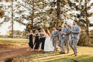 Gledswood Wedding - bridal party walk across the venue grounds at sunset