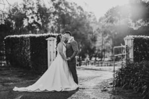 Gledswood Wedding - bride and groom kiss in the venue driveway
