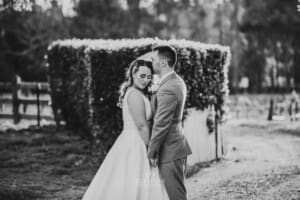 Gledswood Wedding - groom kisses the bride in the venue driveway