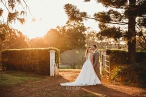 Gledswood wedding - newlyweds stand on a driveway in the golden sunset