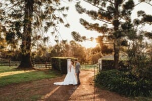 Gledswood Wedding - bride and groom stand in the venue driveway