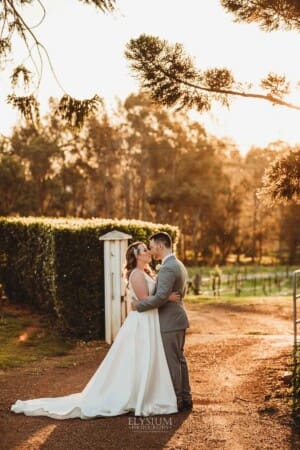 Gledswood Wedding - bride and groom kiss in the venue driveway