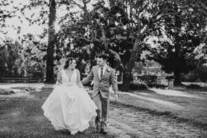 Gledswood Wedding - bride and groom walk up the venue driveway