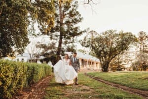 Gledswood Wedding - bride and groom walk up the venue driveway
